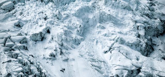 person standing on rock front of snow-capped mountain in nature photography by Will Turner courtesy of Unsplash.